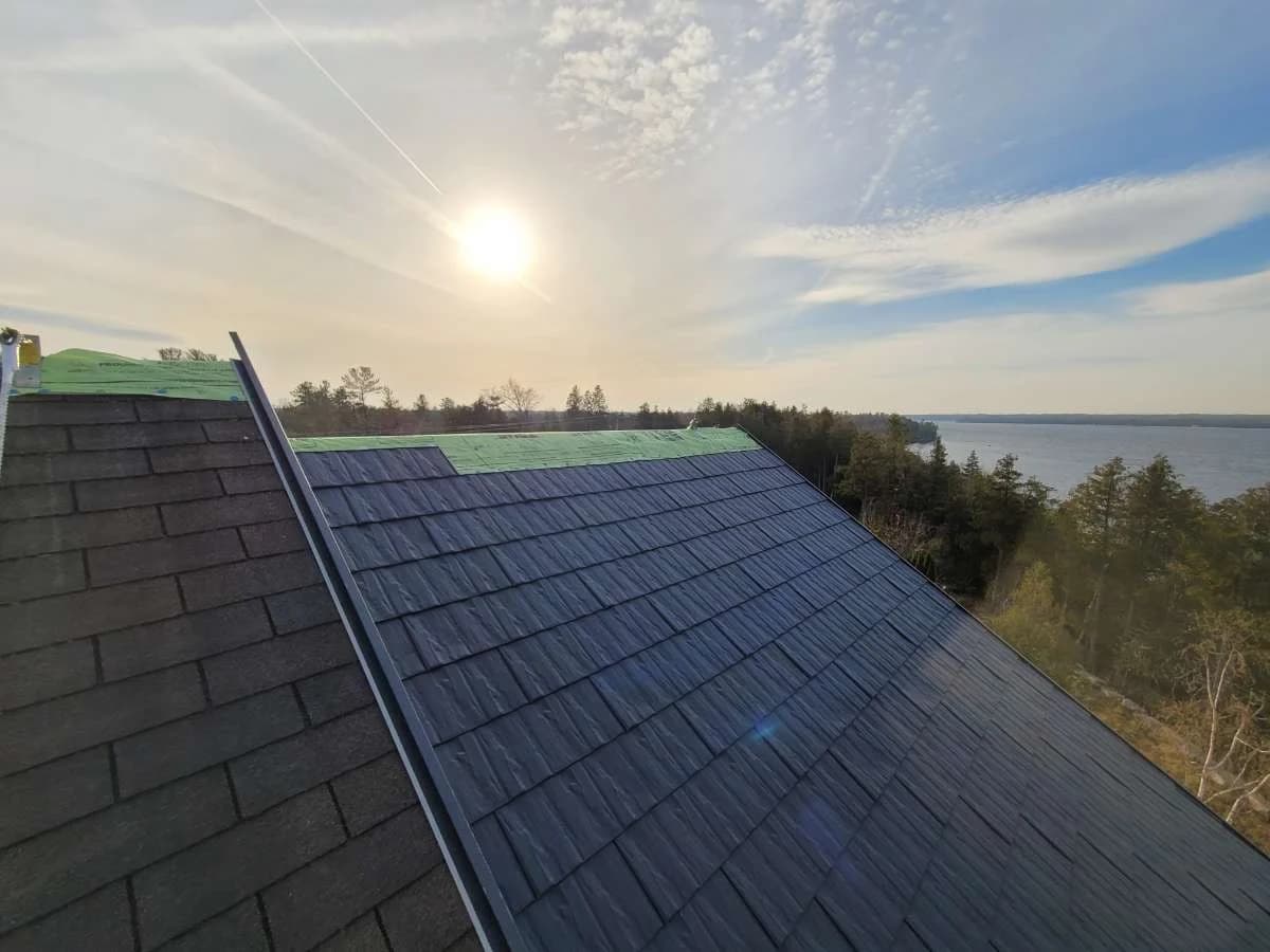 Metal shingle roof overlooking the water at sunset