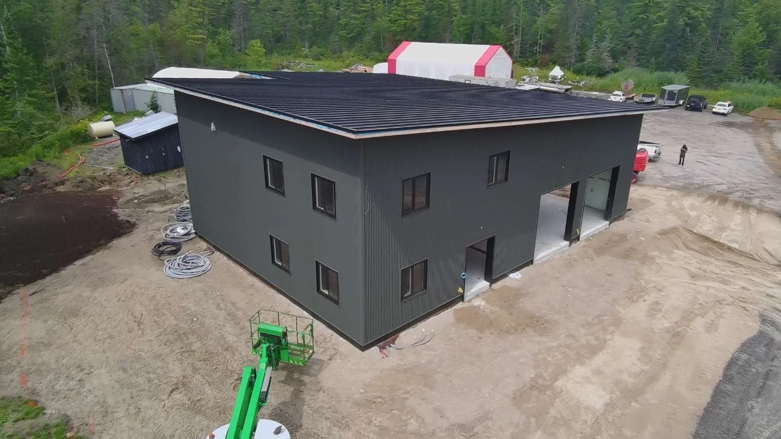 Dark metal siding and roofing on a building under construction