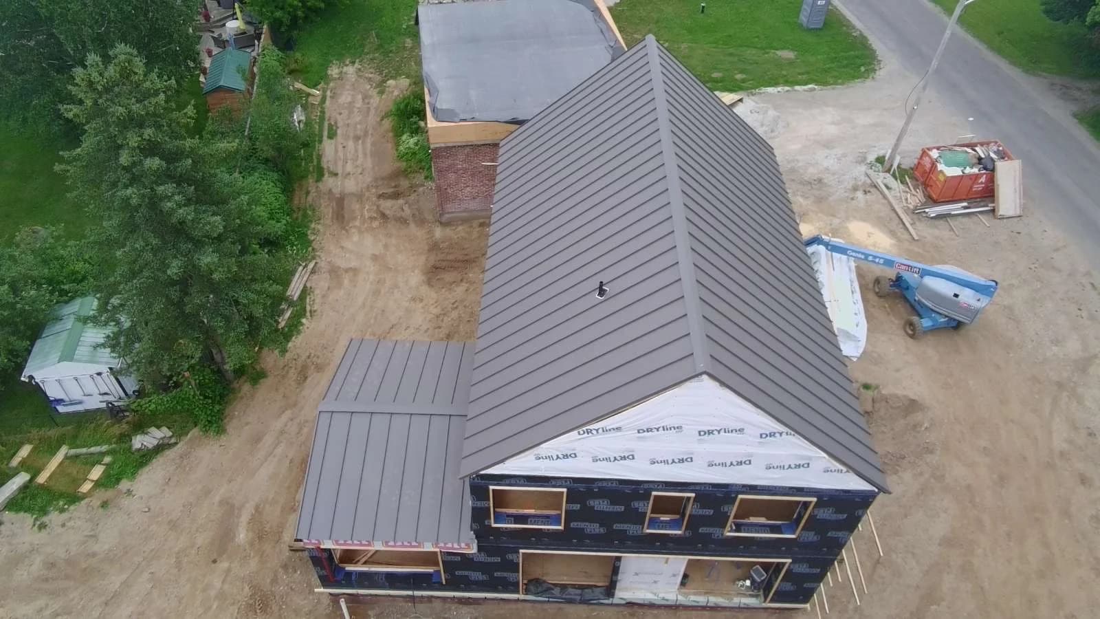 Aerial view along the ridge of a standing seam roof during construction