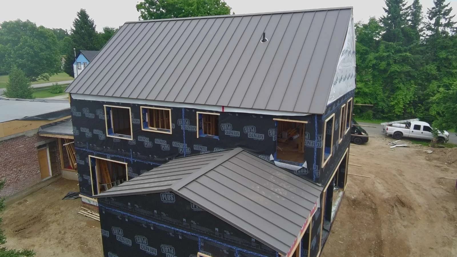 Metal roofing across the main roof and porch of a new home