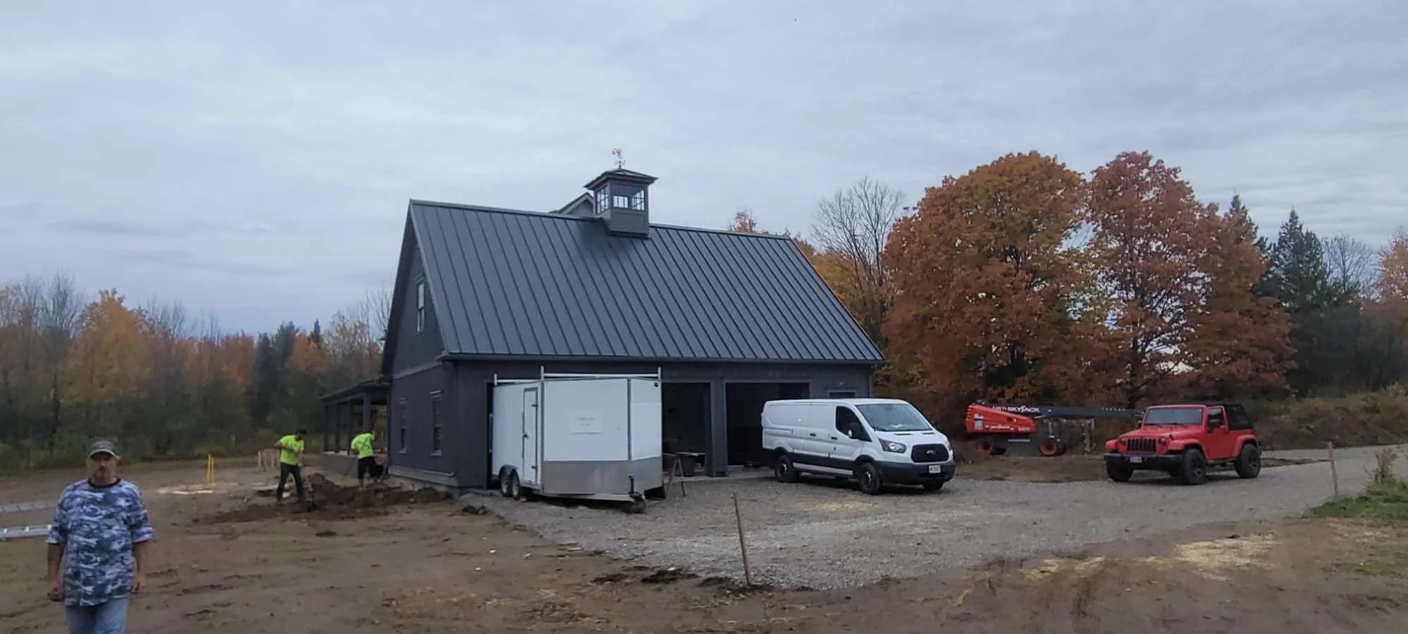 Front view of a metal-roofed garage with a cupola