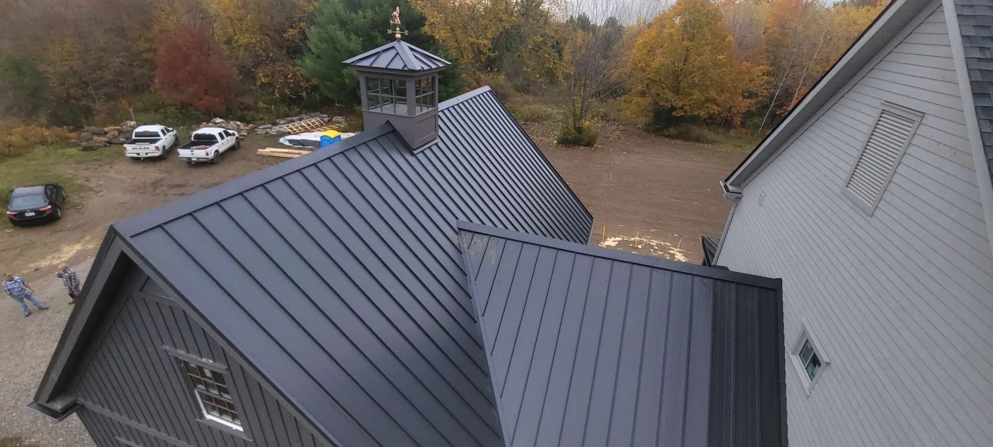 Standing seam roof with intersecting gables and a cupola
