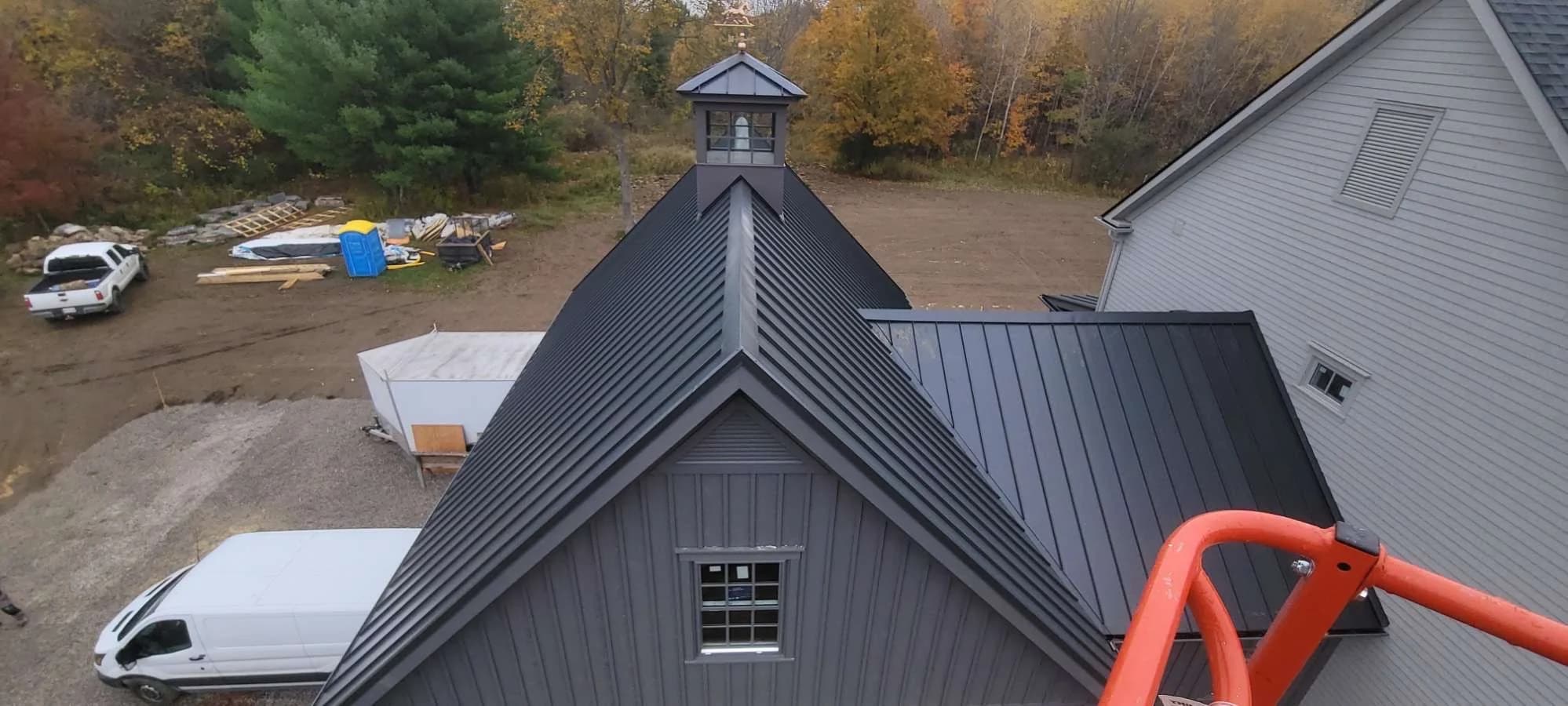 Metal roof ridge leading to a cupola