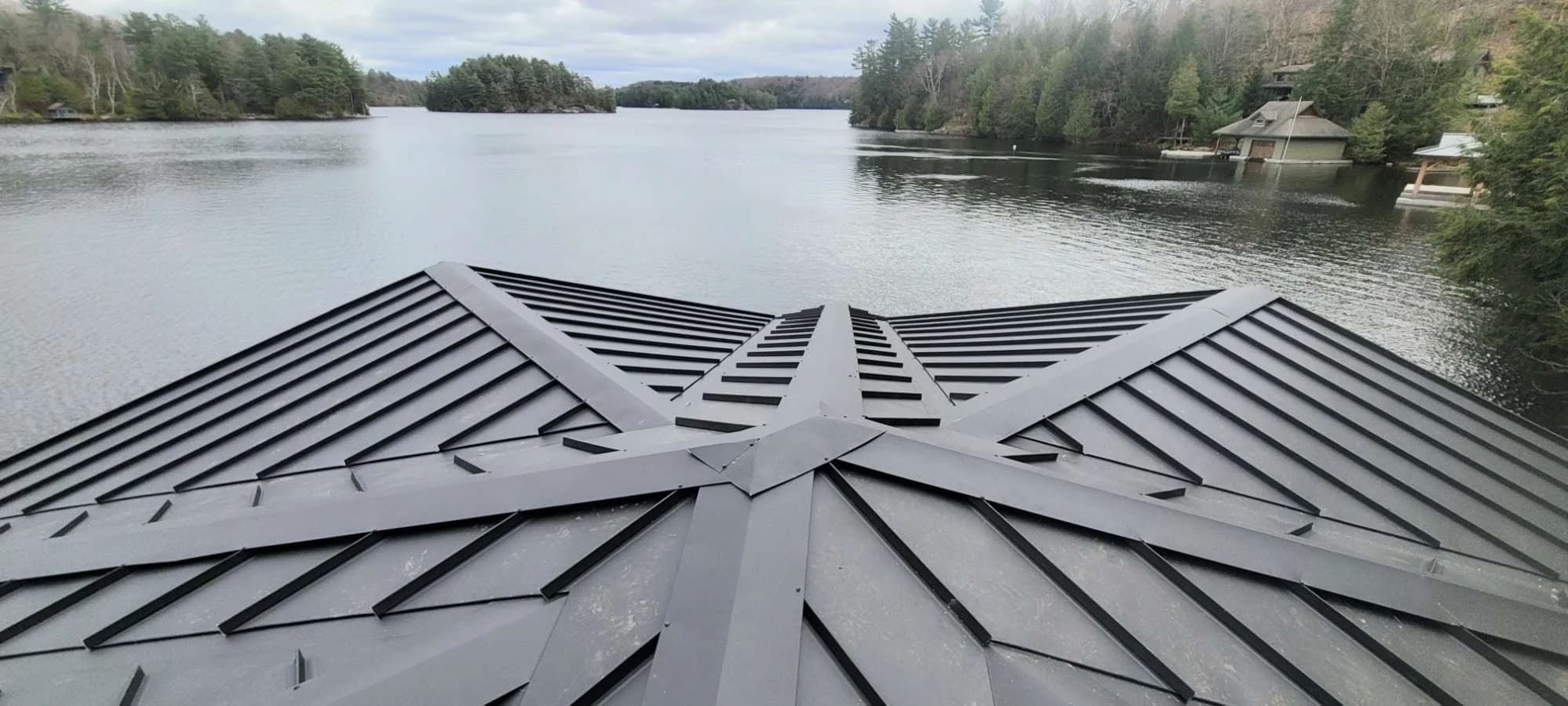 Standing seam roof intersections facing a wooded lake