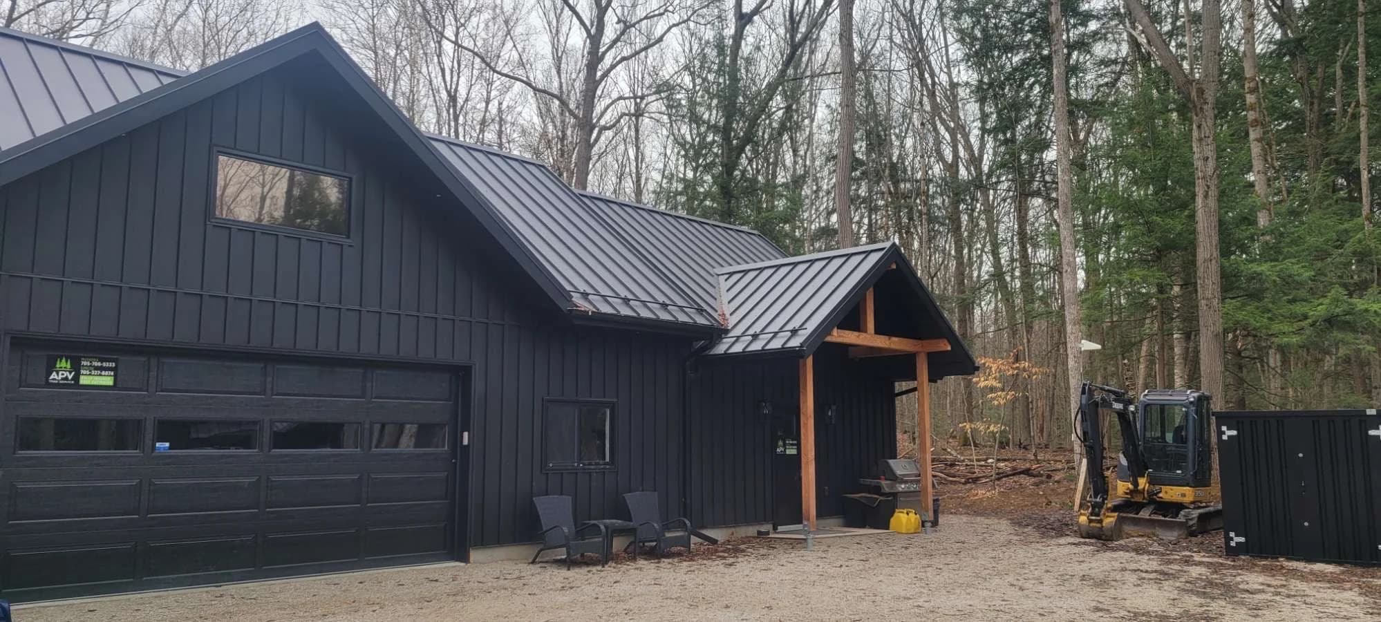 Metal-roofed garage and adjoining entrance in the woods