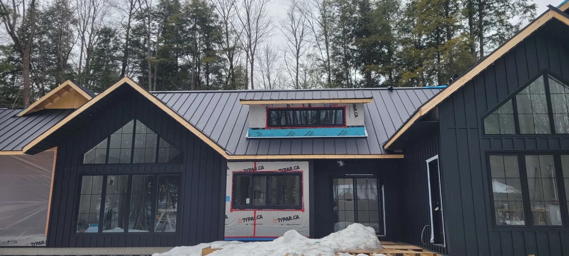 Metal roofing on a woodland home during construction