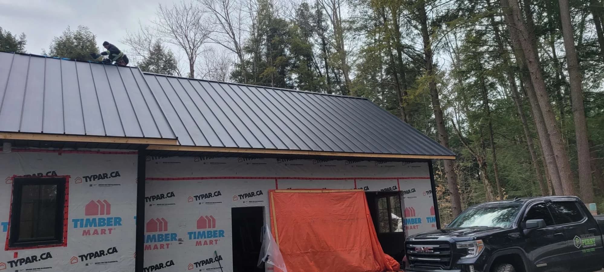 Standing seam roof over a garage under construction