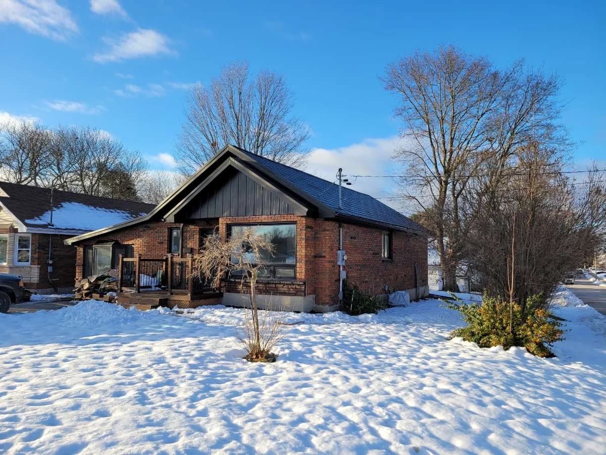 Metal-roofed home in a snowy landscape