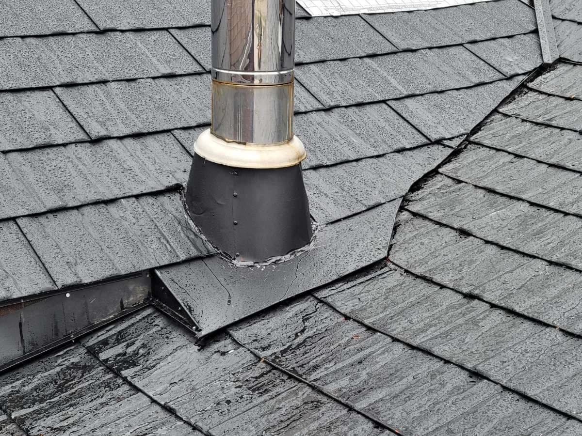 Flue flashing on a metal shingle roof