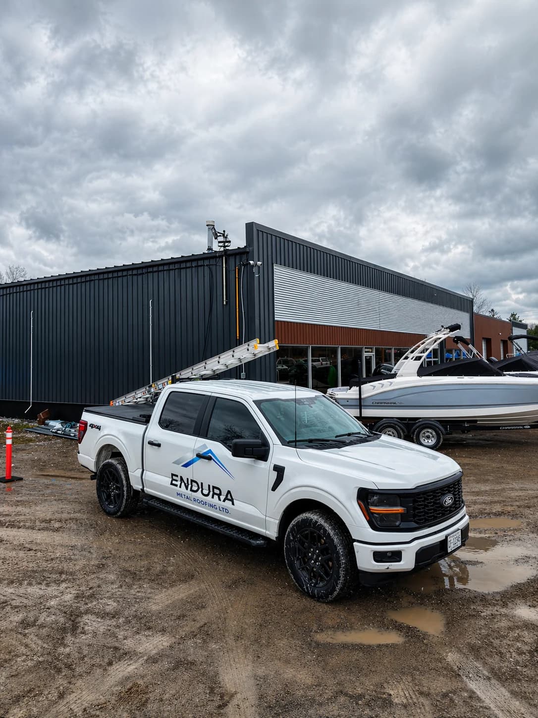 An Endura truck on site outside a building with metal roofing and siding